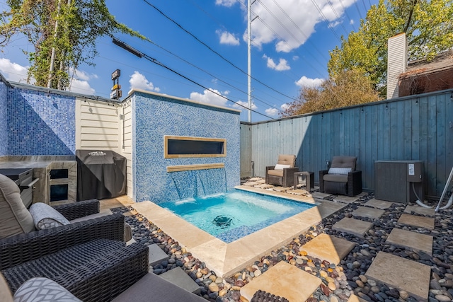 view of pool with grilling area, an outdoor living space, central AC unit, and pool water feature