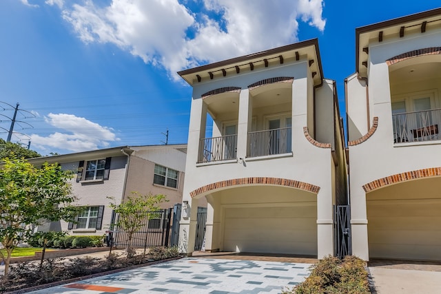 mediterranean / spanish-style home with a balcony and a garage