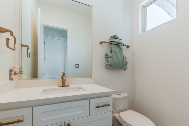 bathroom featuring toilet and vanity