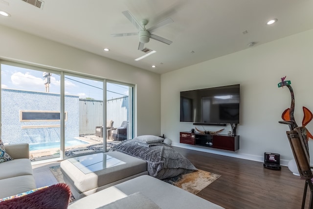 living room with dark wood-type flooring and ceiling fan