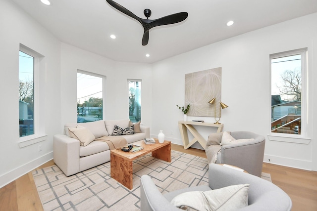 living room featuring ceiling fan and light hardwood / wood-style flooring