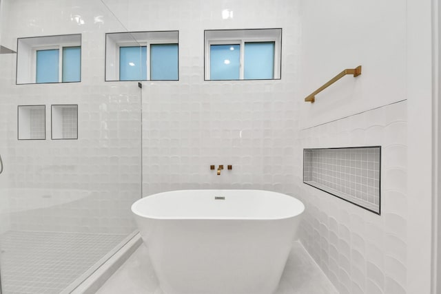 bathroom with independent shower and bath and tile walls