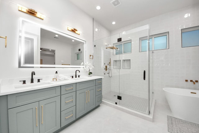 bathroom with independent shower and bath, vanity, tile walls, and tile patterned floors