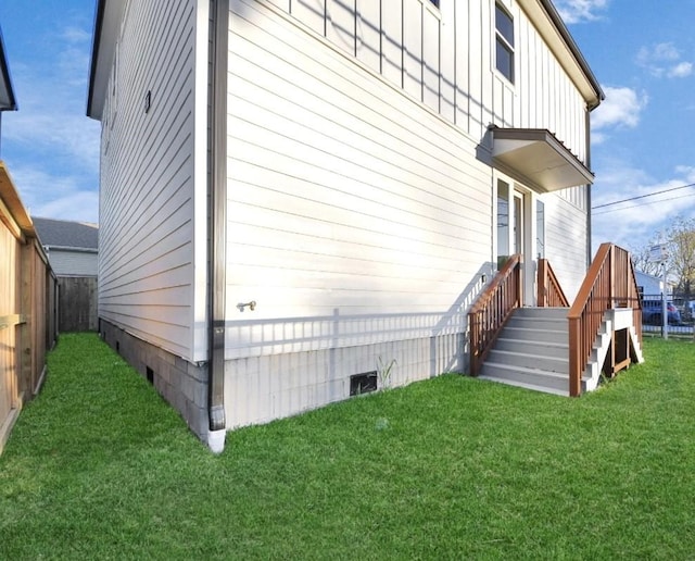 view of side of home featuring a lawn