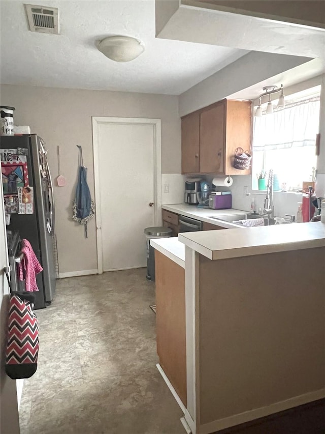 kitchen featuring kitchen peninsula, appliances with stainless steel finishes, and sink