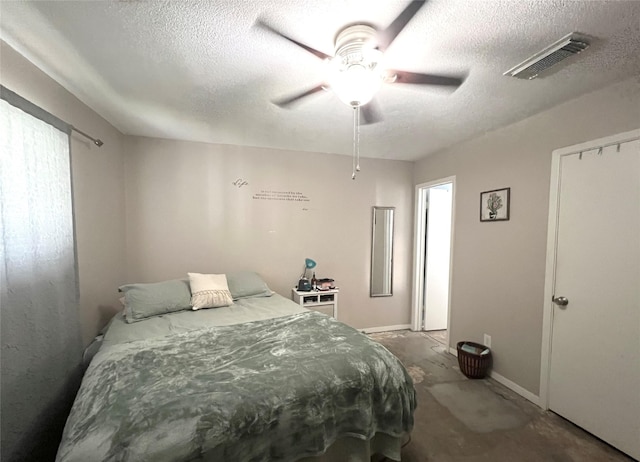 bedroom featuring a textured ceiling, ceiling fan, and concrete flooring