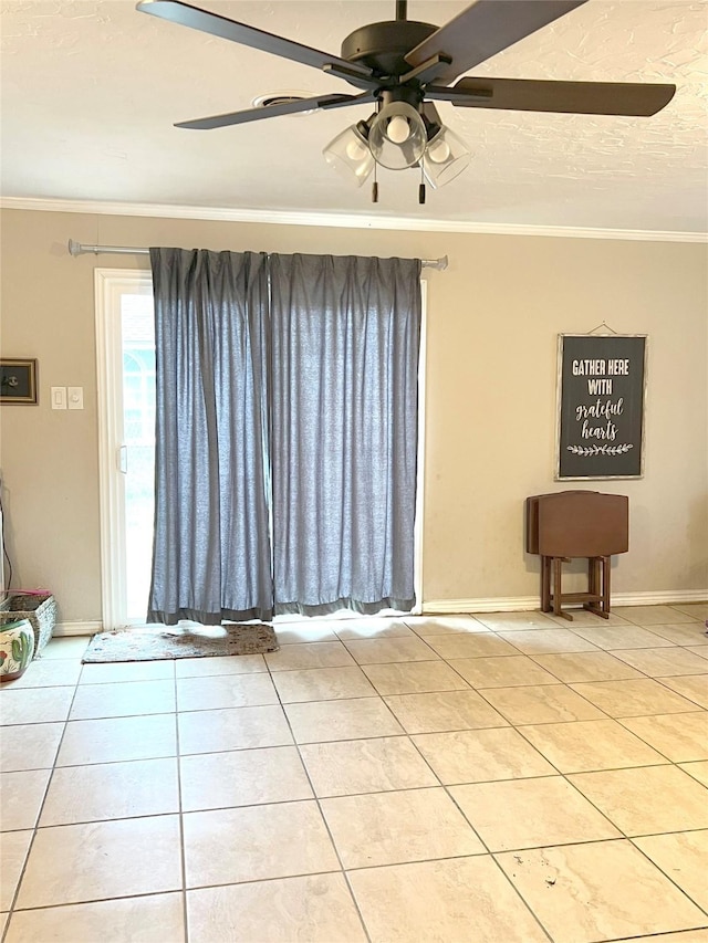 tiled spare room with ceiling fan and crown molding