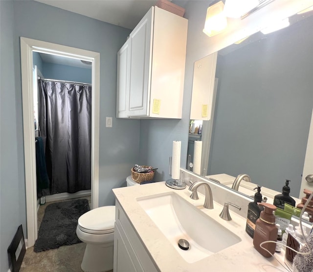 bathroom with toilet and vanity