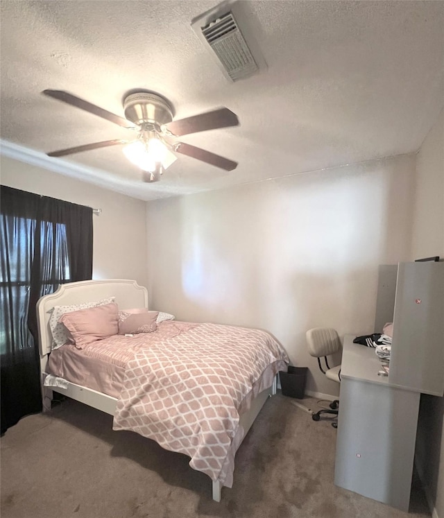 carpeted bedroom with a textured ceiling and ceiling fan