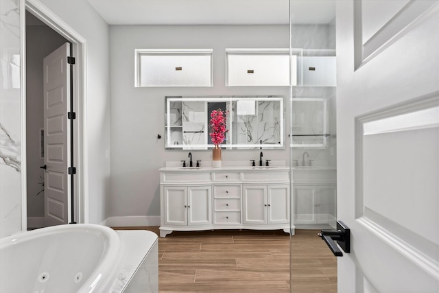 bathroom featuring a tub to relax in and vanity