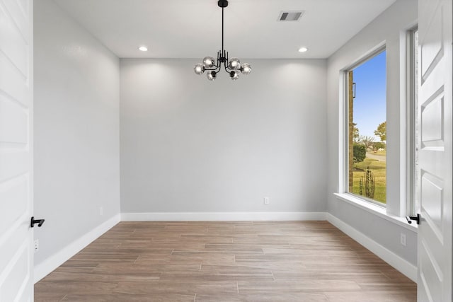 spare room featuring a chandelier