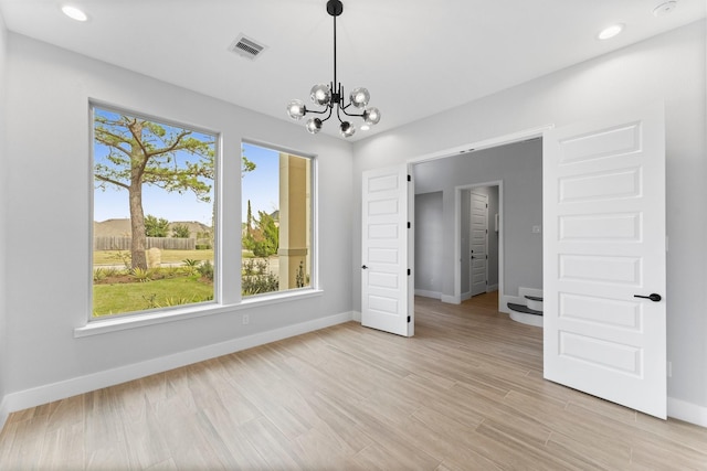 unfurnished bedroom featuring a chandelier