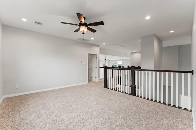 empty room with ceiling fan and light colored carpet