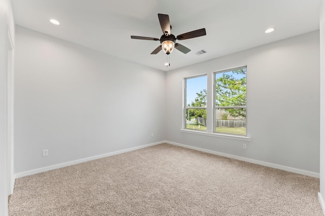 carpeted spare room with ceiling fan