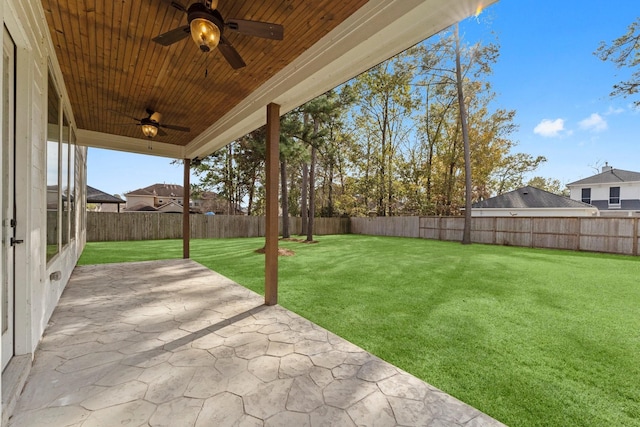 view of yard with ceiling fan and a patio area