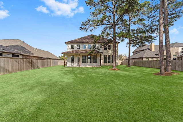 rear view of house with a lawn