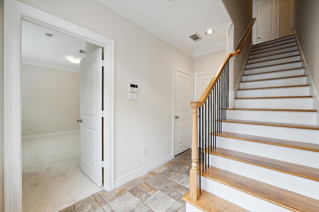 staircase with carpet and crown molding