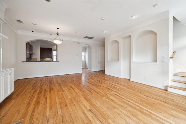 unfurnished living room with light wood-type flooring and crown molding