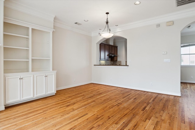 unfurnished dining area with ornamental molding and light hardwood / wood-style flooring