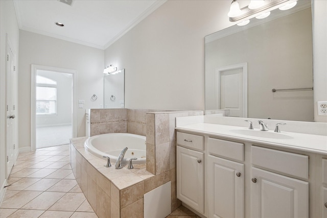 bathroom featuring tiled bath, tile patterned flooring, crown molding, and vanity