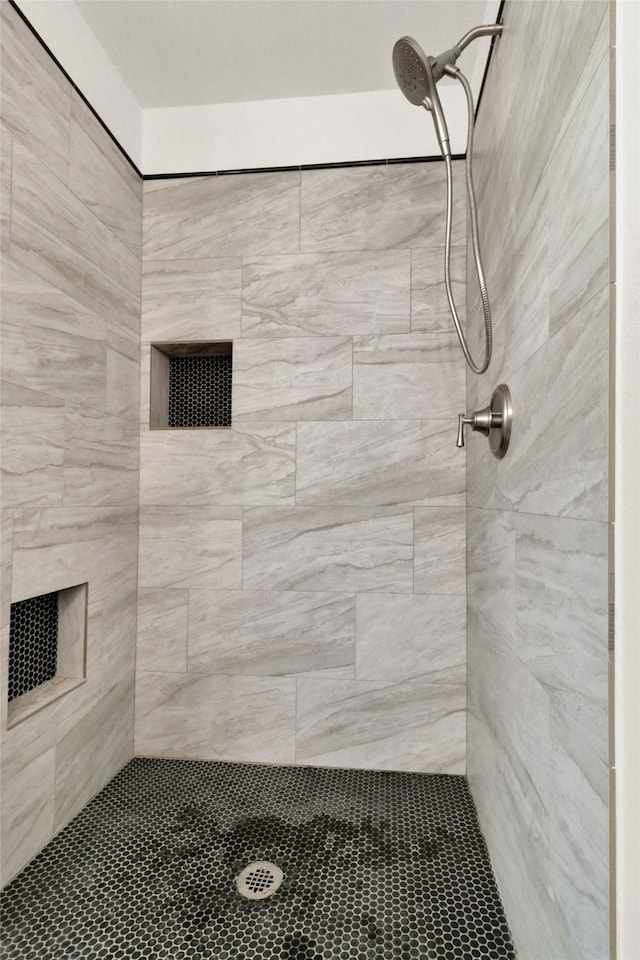 bathroom with a tile shower