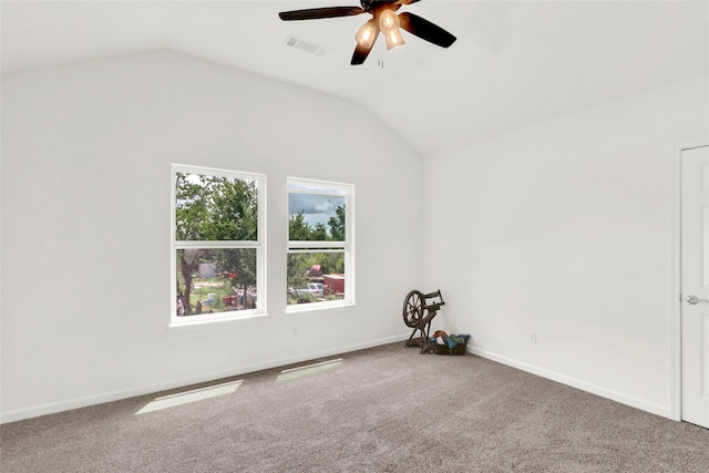 empty room featuring vaulted ceiling, ceiling fan, and carpet flooring