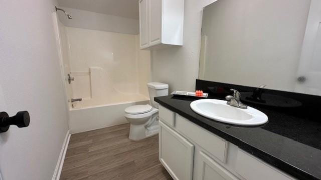 full bathroom featuring toilet, hardwood / wood-style floors, vanity, and shower / bathing tub combination