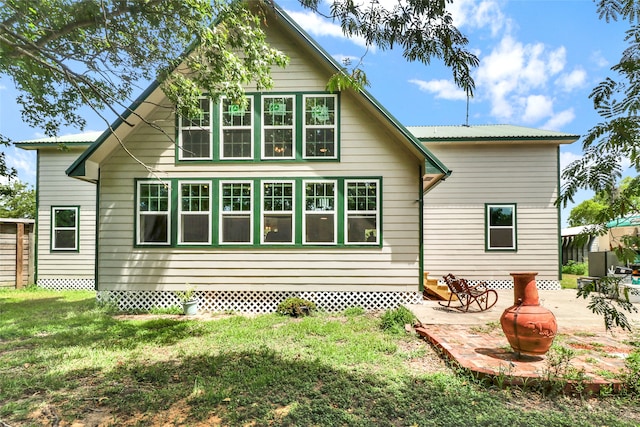 back of house with a patio area and a yard