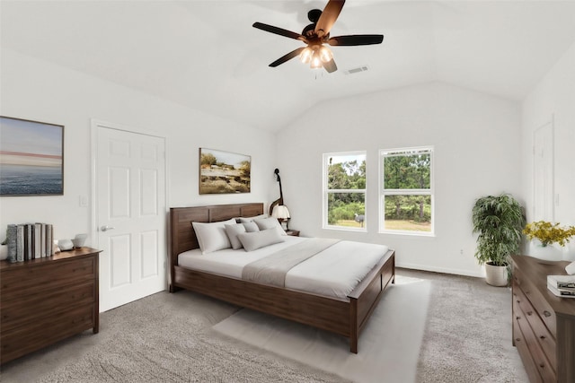 bedroom with vaulted ceiling, ceiling fan, and carpet floors