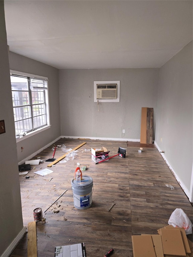 unfurnished room with an AC wall unit