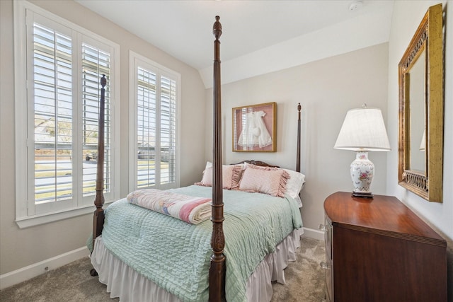 bedroom with vaulted ceiling and light carpet