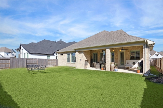 back of property featuring ceiling fan, a yard, and a patio area