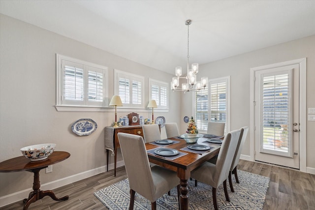 dining area featuring hardwood / wood-style floors and a chandelier