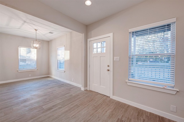 foyer featuring light hardwood / wood-style flooring and a notable chandelier