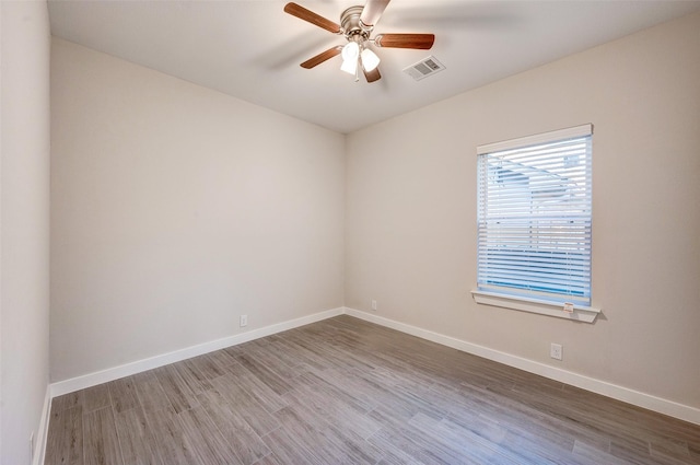 spare room featuring ceiling fan and hardwood / wood-style floors