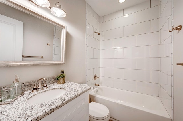 full bathroom featuring toilet, tiled shower / bath combo, and vanity