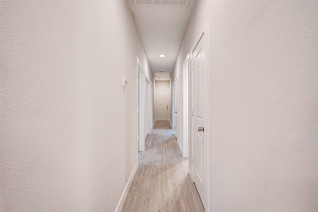 corridor with light hardwood / wood-style flooring