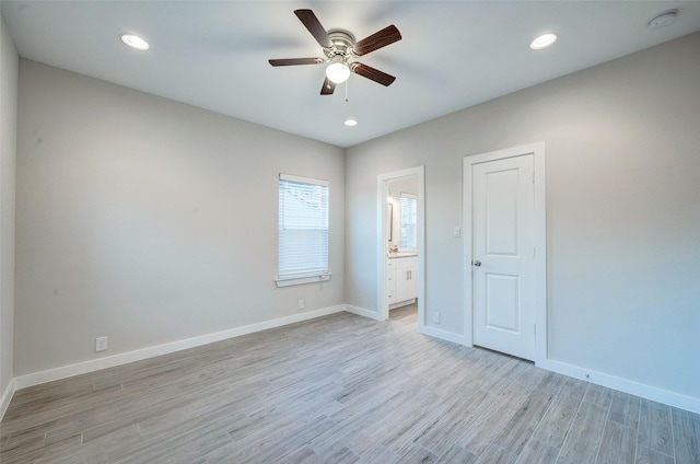 unfurnished bedroom with ceiling fan, connected bathroom, and light hardwood / wood-style floors