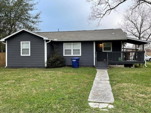 view of front of property featuring a front yard and a deck