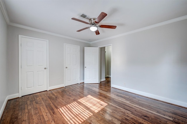 unfurnished bedroom with ceiling fan, crown molding, and wood-type flooring