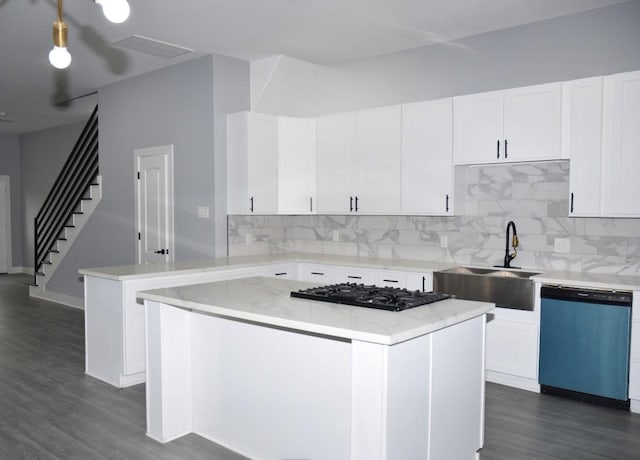 kitchen featuring a kitchen island, dishwasher, white cabinetry, and sink