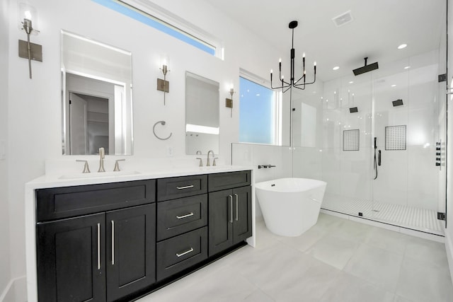 bathroom featuring plus walk in shower, vanity, and an inviting chandelier