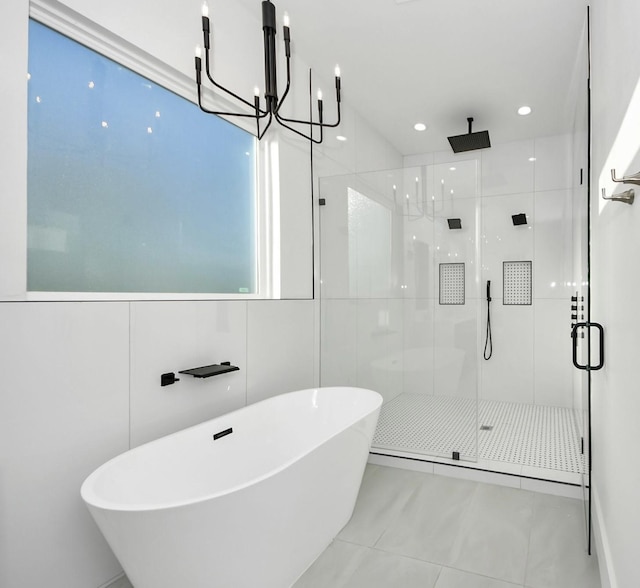 bathroom featuring independent shower and bath, tile walls, tile patterned floors, and an inviting chandelier