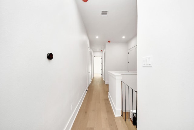 corridor with light hardwood / wood-style flooring