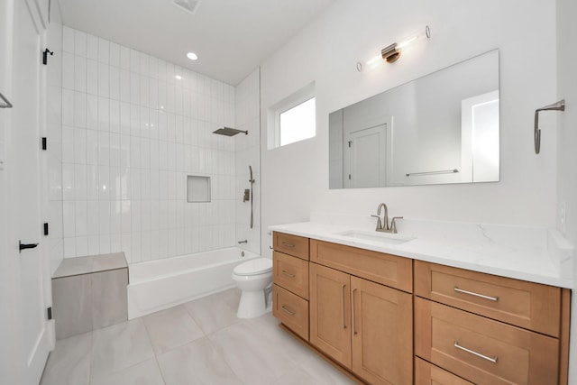 full bathroom with tiled shower / bath, vanity, toilet, and tile patterned flooring