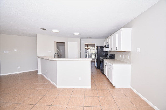 kitchen with black appliances, white cabinets, backsplash, light tile patterned floors, and kitchen peninsula