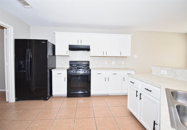 kitchen with white cabinetry, black appliances, and light tile patterned flooring