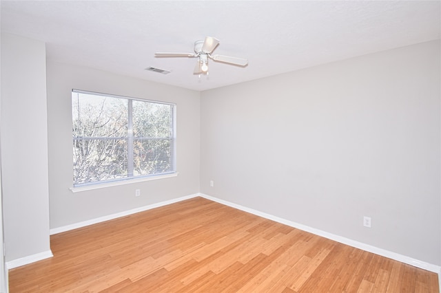 empty room featuring ceiling fan and light hardwood / wood-style flooring