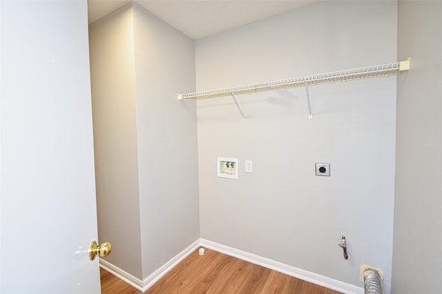 laundry room featuring hardwood / wood-style floors, hookup for a washing machine, hookup for an electric dryer, and hookup for a gas dryer