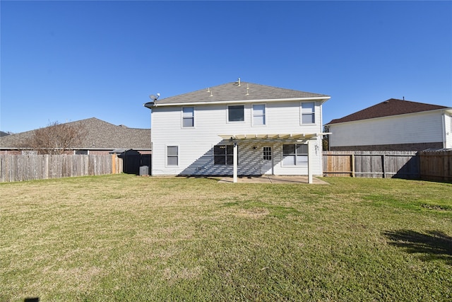 rear view of property with a yard, a pergola, and a patio area